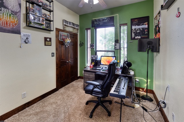 carpeted office space featuring ceiling fan