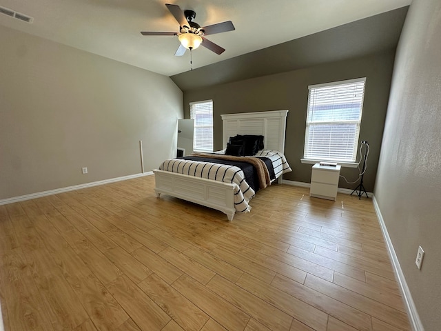 bedroom with light hardwood / wood-style floors, lofted ceiling, and ceiling fan