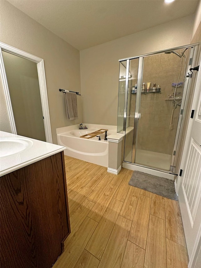 2205 Willow Creek Dr, Little Elm, TX 75068 - bathroom with vanity, separate shower and tub, and hardwood / wood-style floors
