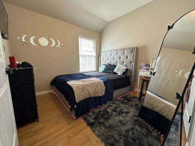 bedroom featuring wood-type flooring and lofted ceiling