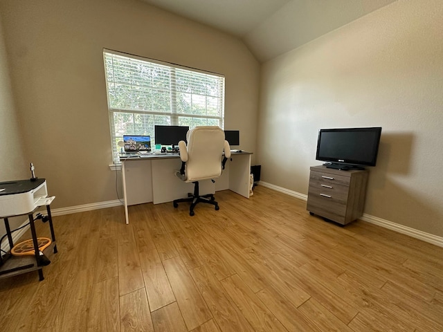 office space featuring lofted ceiling and light hardwood / wood-style floors