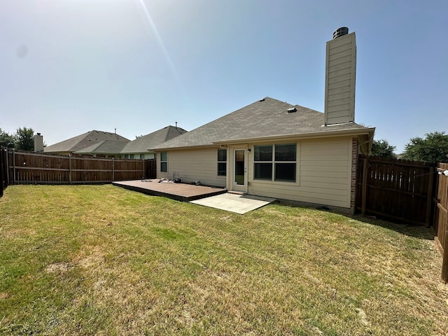 rear view of house featuring a patio and a lawn