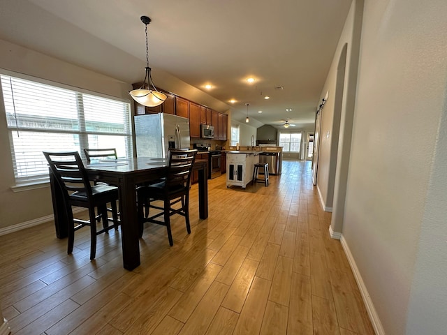 dining room with sink and light hardwood / wood-style flooring