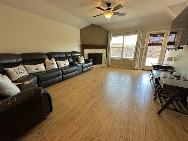 2205 Willow Creek Dr, Little Elm, TX 75068 - living room featuring ceiling fan, vaulted ceiling, a brick fireplace, and light wood-type flooring