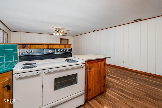 kitchen featuring ceiling fan, ornamental molding, dark hardwood / wood-style flooring, and range with two ovens