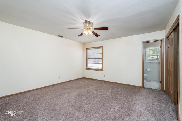 unfurnished bedroom featuring ceiling fan, connected bathroom, and carpet floors