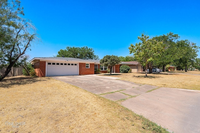 ranch-style home with a garage and a front yard