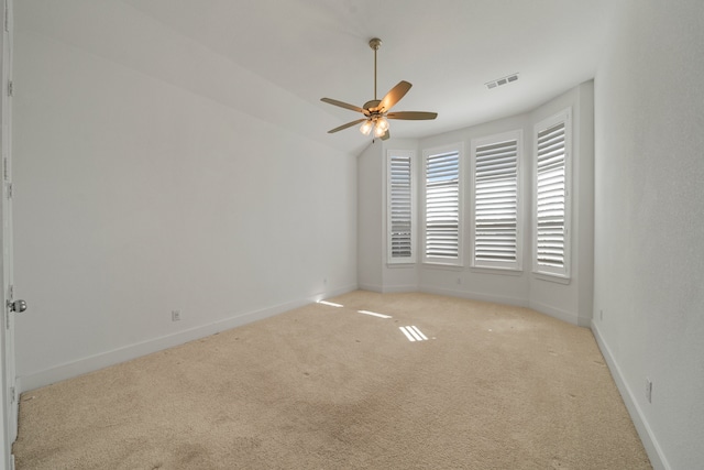 carpeted empty room with ceiling fan and vaulted ceiling