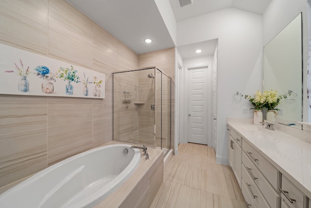 bathroom featuring tile patterned flooring, vanity, and separate shower and tub