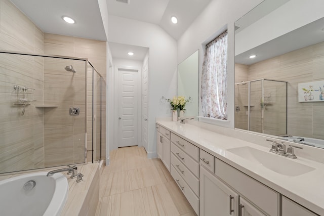 bathroom featuring lofted ceiling, vanity, and independent shower and bath