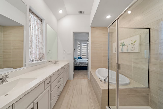 bathroom featuring lofted ceiling, vanity, tile patterned flooring, and shower with separate bathtub