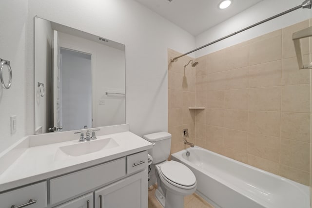 full bathroom with vanity, tiled shower / bath combo, and toilet