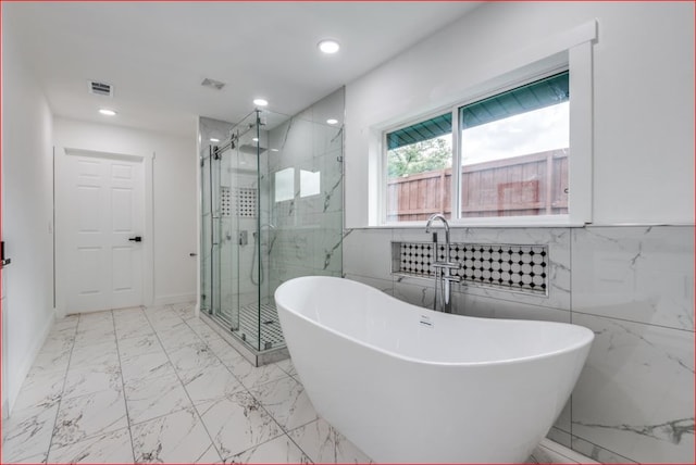 bathroom featuring tile walls, separate shower and tub, and tile patterned floors