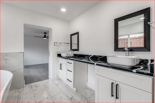 bathroom with a tub to relax in, tile patterned flooring, dual bowl vanity, and ceiling fan