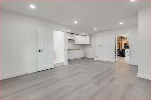 unfurnished living room featuring light hardwood / wood-style floors