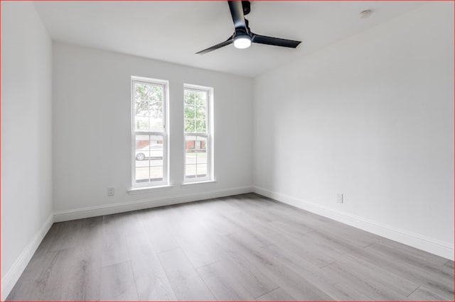 empty room featuring ceiling fan and light hardwood / wood-style floors