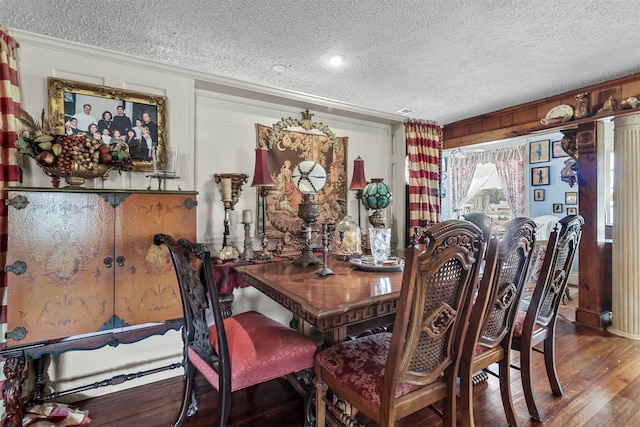 dining area with a textured ceiling and hardwood / wood-style floors