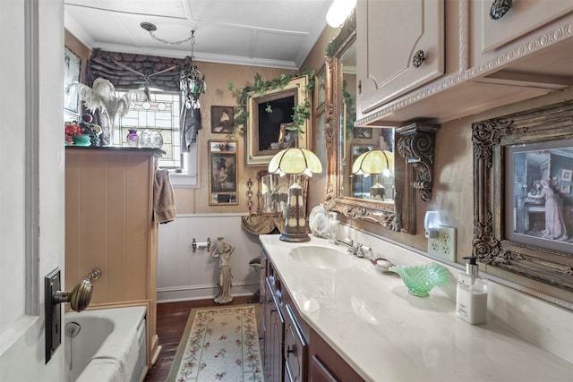 bathroom featuring vanity, crown molding, and hardwood / wood-style floors