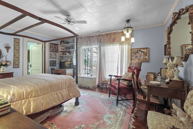 bedroom featuring crown molding, dark hardwood / wood-style flooring, and ceiling fan