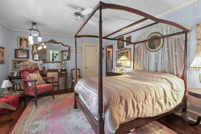 bedroom featuring hardwood / wood-style flooring, crown molding, and ceiling fan