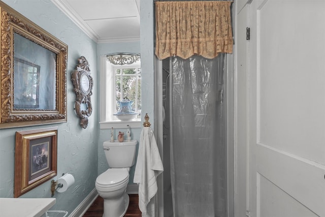 bathroom with wood-type flooring, crown molding, toilet, and vanity