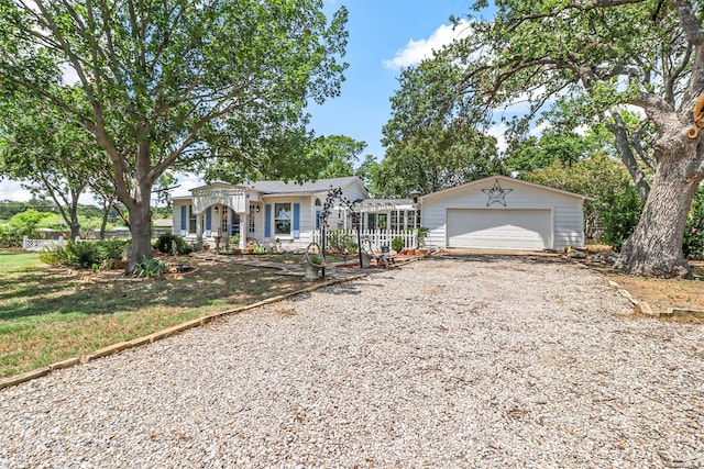 single story home featuring a garage and an outbuilding