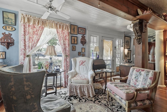 living area with hardwood / wood-style floors and ceiling fan