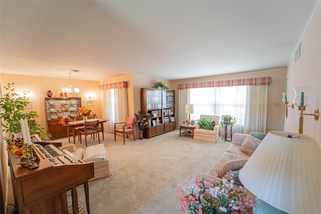 carpeted living room with a chandelier