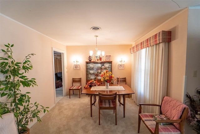 carpeted dining room featuring an inviting chandelier and ornamental molding