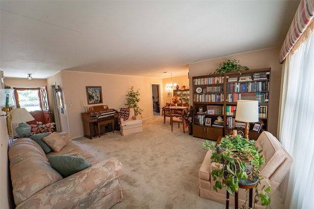 carpeted living room featuring a chandelier