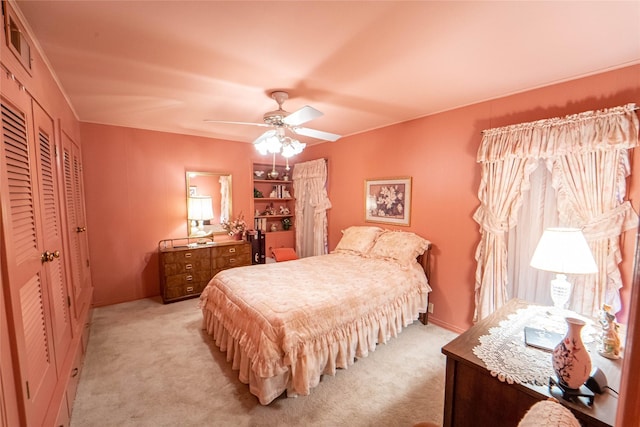 bedroom with light carpet and ceiling fan