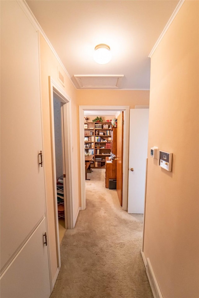 hallway with crown molding and light carpet