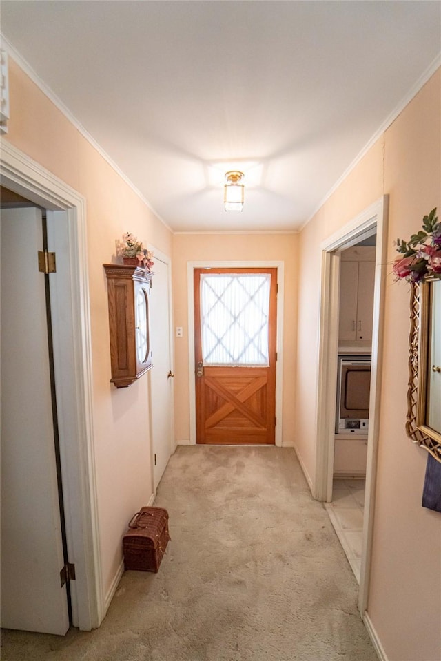 doorway to outside featuring ornamental molding and light carpet