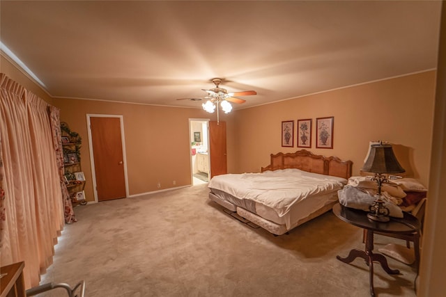 carpeted bedroom with ceiling fan, ornamental molding, and connected bathroom