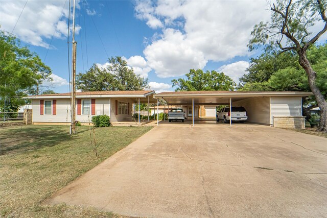 view of front facade with a front lawn and a carport