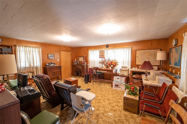 office area with carpet flooring, wooden walls, and a wealth of natural light