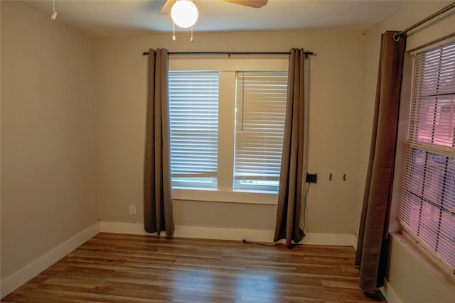 spare room with hardwood / wood-style flooring and ceiling fan