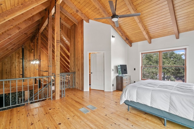 unfurnished bedroom with beam ceiling, wood-type flooring, ceiling fan, and wooden ceiling