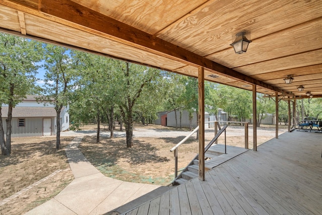 wooden deck with a storage shed