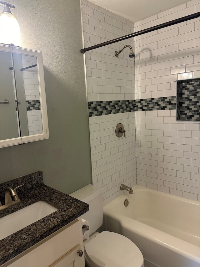 full bathroom with toilet, tiled shower / bath combo, and vanity