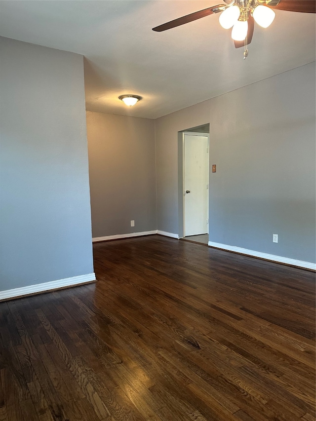 spare room with ceiling fan and dark hardwood / wood-style floors