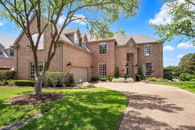 view of front of property featuring a garage and a front lawn