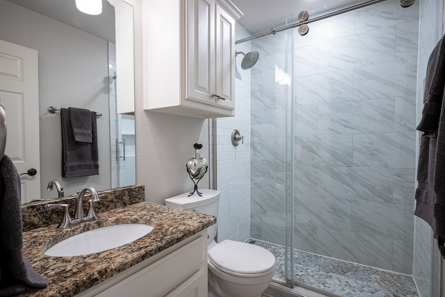 bathroom featuring walk in shower, vanity, and toilet