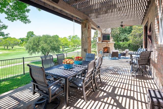 view of patio featuring an outdoor stone fireplace and a pergola