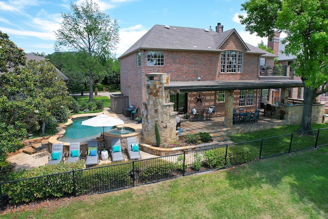 rear view of property featuring a balcony and a patio