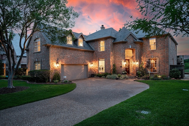 view of front facade with a lawn and a garage