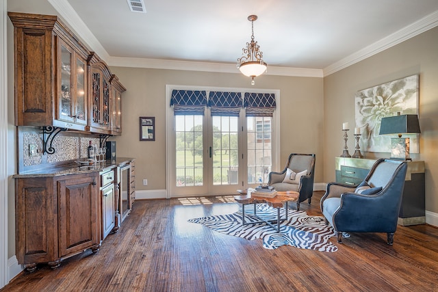 sitting room featuring dark hardwood / wood-style flooring and ornamental molding