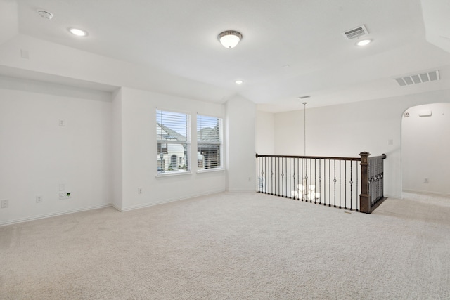 unfurnished room featuring light carpet