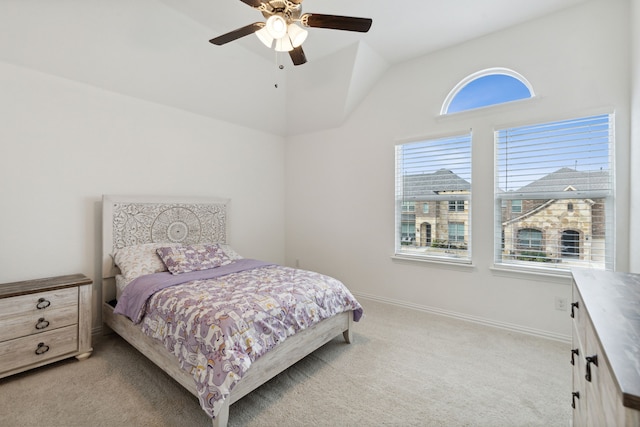 carpeted bedroom featuring multiple windows, lofted ceiling, and ceiling fan