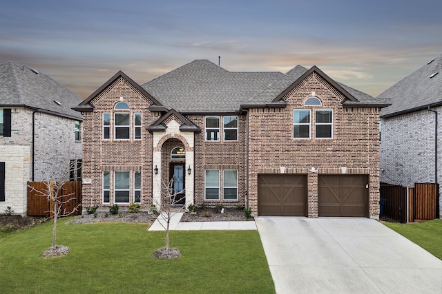 view of front of house with a yard and a garage